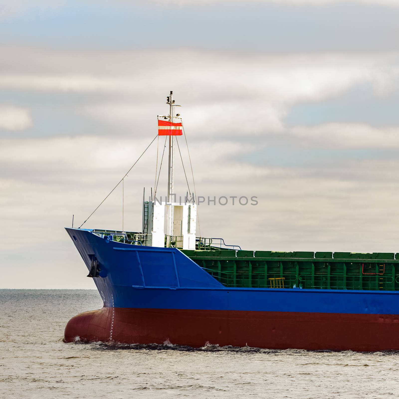 Blue cargo ship's bow leaving the port of Riga