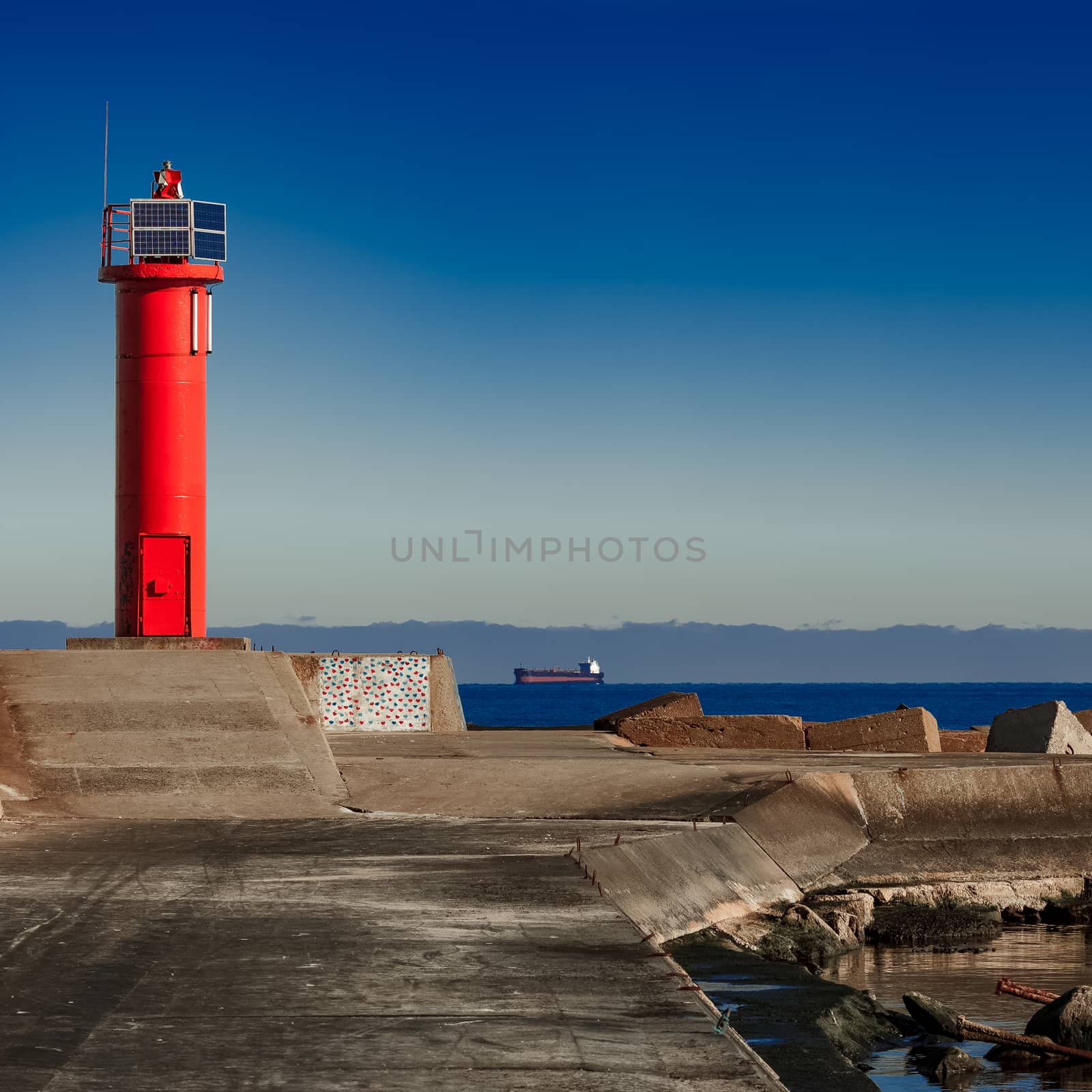 Red lighthouse on breakwater dam in Riga, Europe