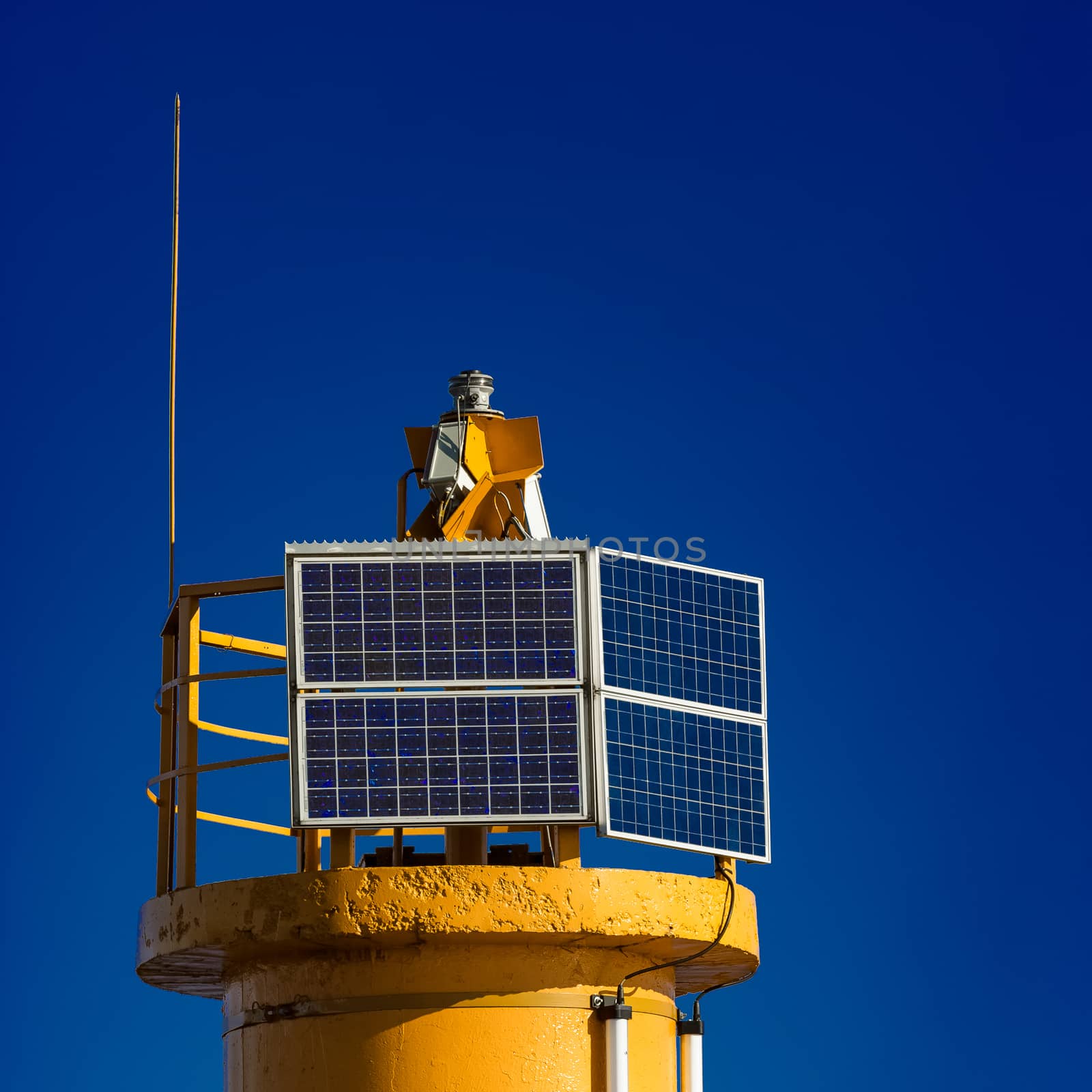 Yellow lighthouse against blue sky in Riga, Europe