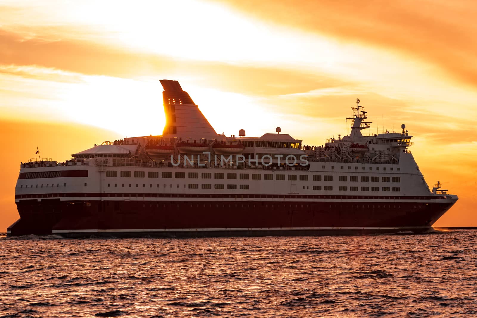 Cruise liner leaving Riga. Passenger ferry sailing at hot sunset