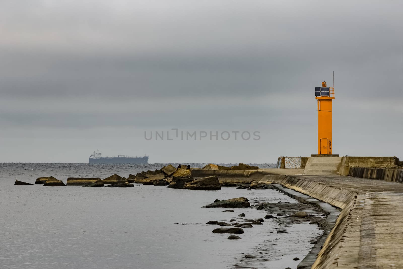 Breakwater dam with yellow lighthouse in Riga, Europe