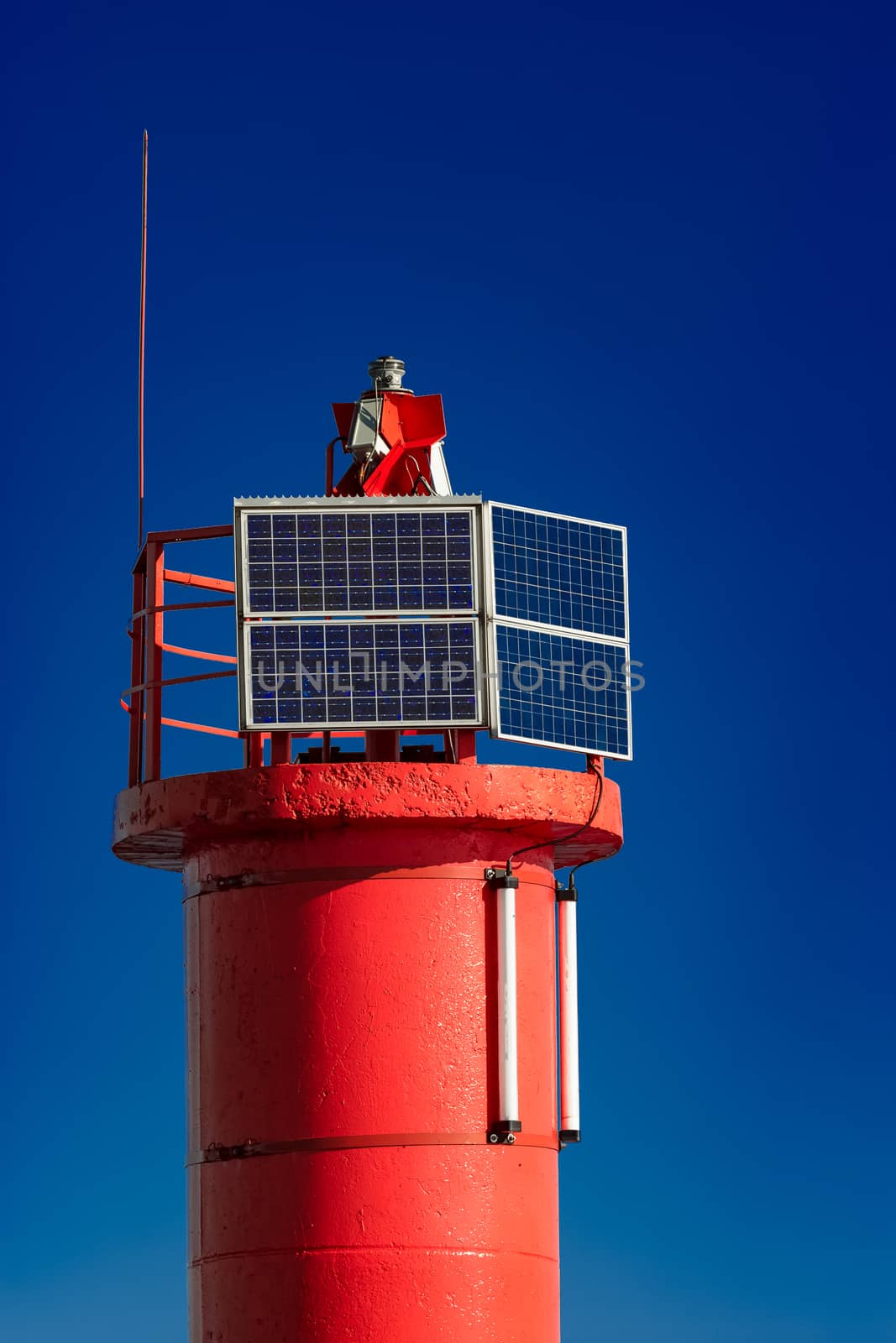 Red lighthouse against blue sky by sengnsp