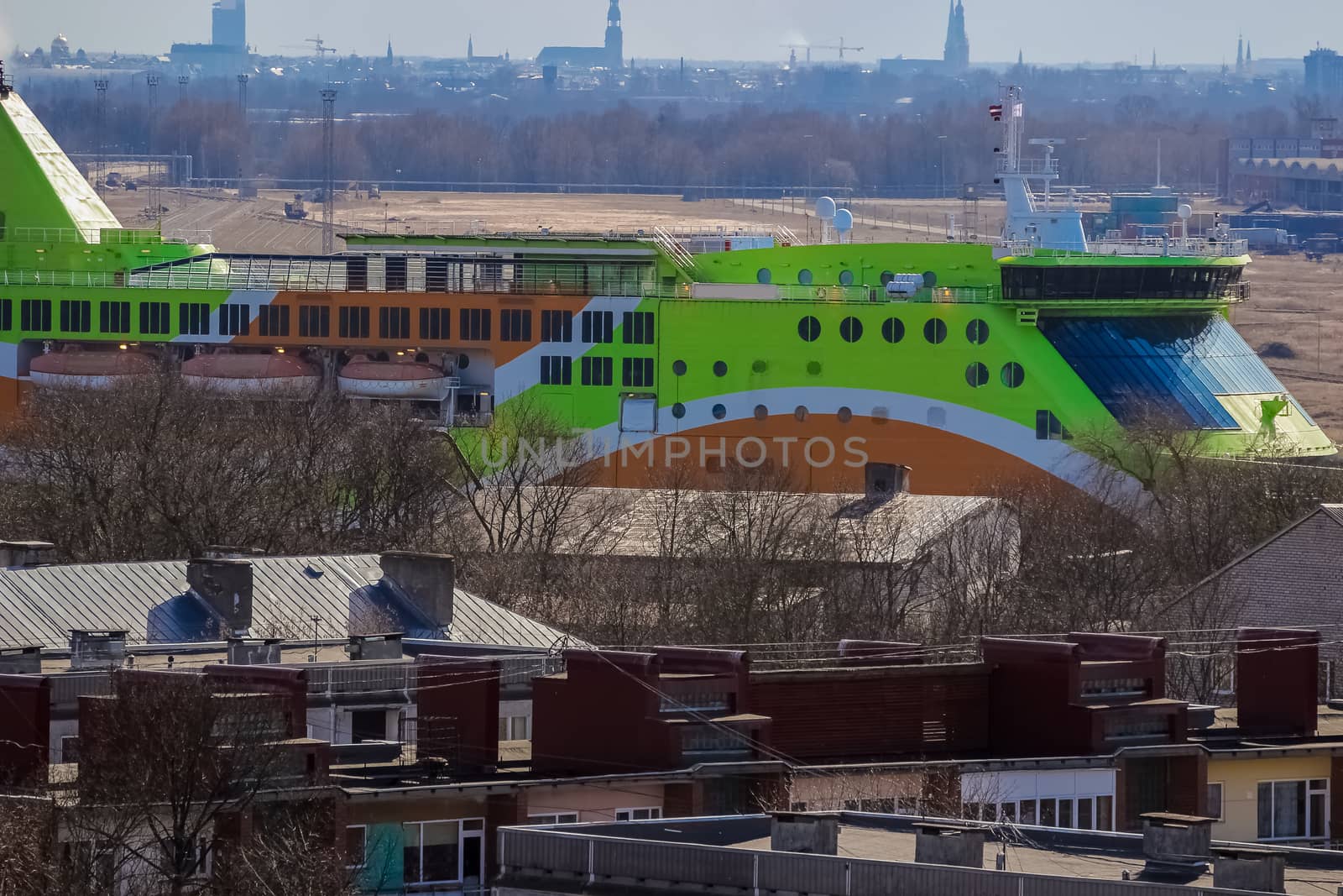 Green cruise liner. Passenger ferry sailing past the Riga city