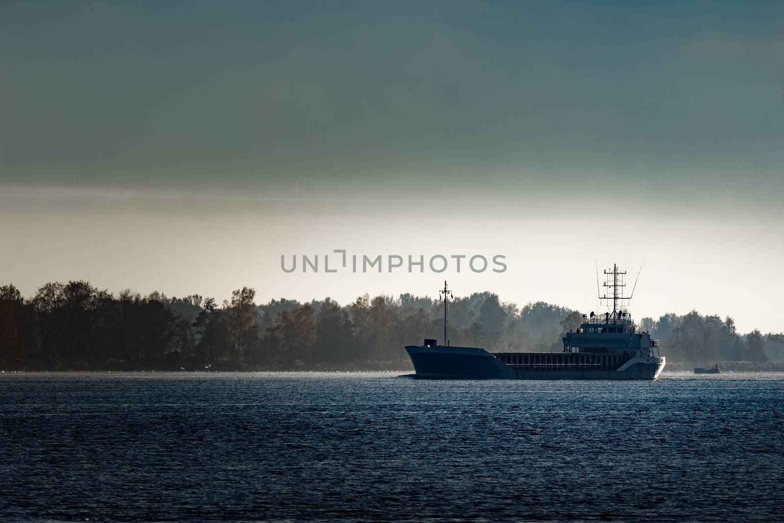 Blue cargo ship leaving Riga and entering Baltic sea