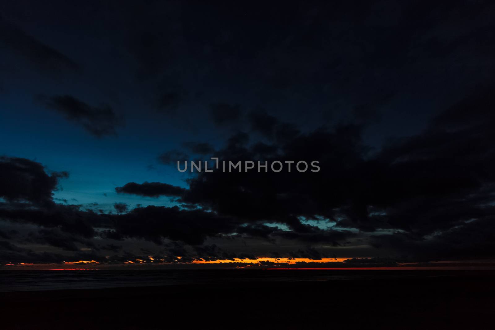 Dark blue cloudy sky over the Baltic sea at night