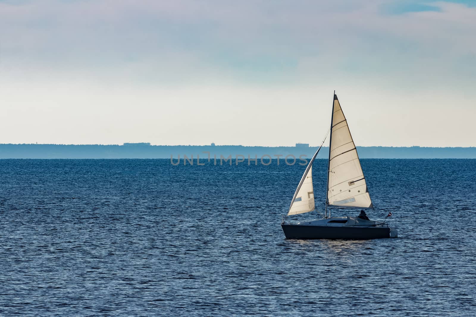 White sailboat traveling in Baltic sea