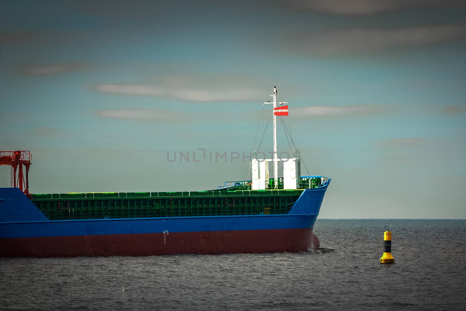 Blue cargo ship's bow leaving the port of Riga