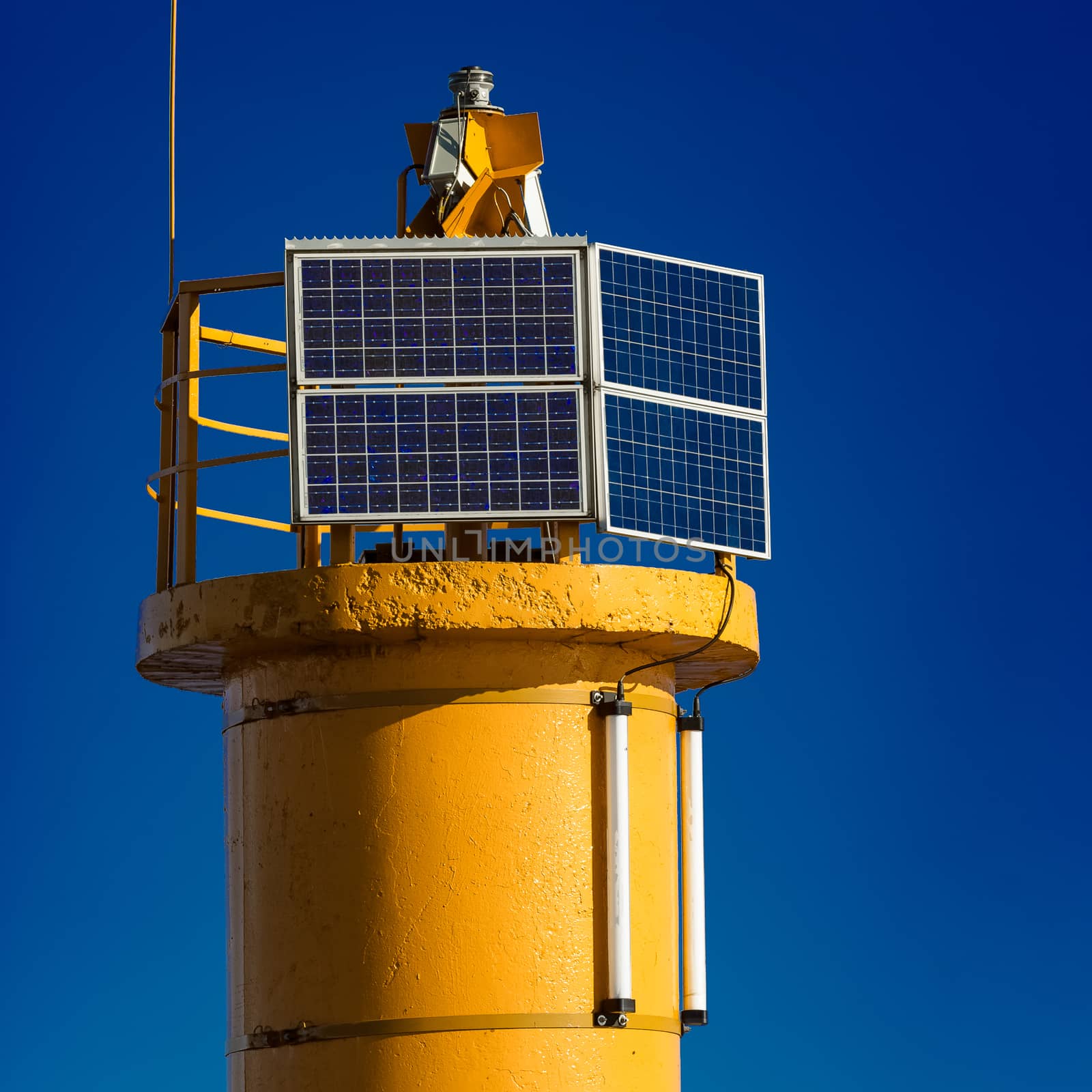 Yellow lighthouse against blue sky in Riga, Europe