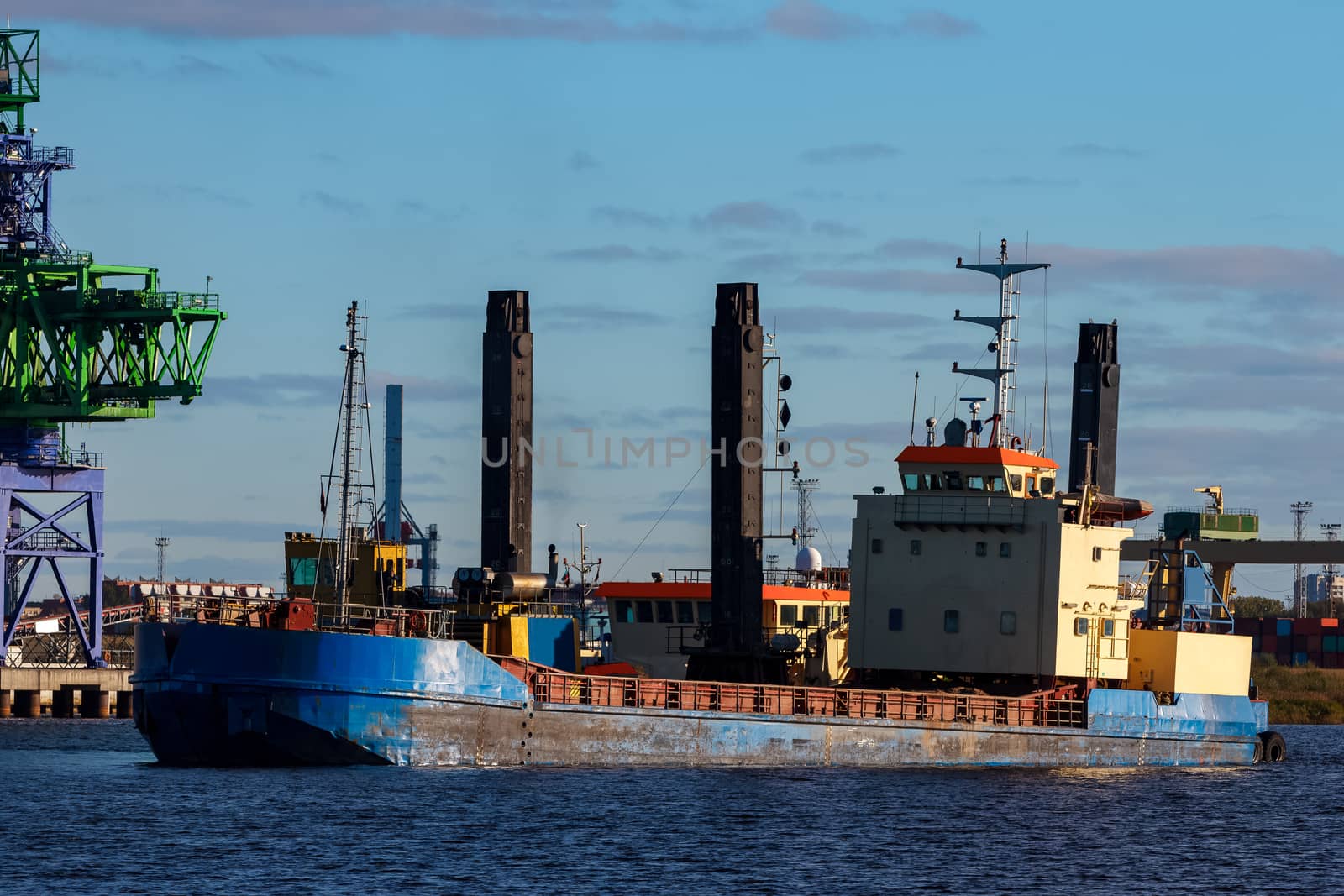 Blue cargo ship in the port of Riga, Europe