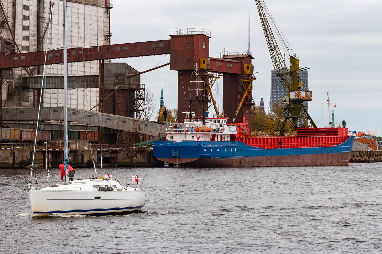 Blue cargo ship loading in the port of Riga, Europe