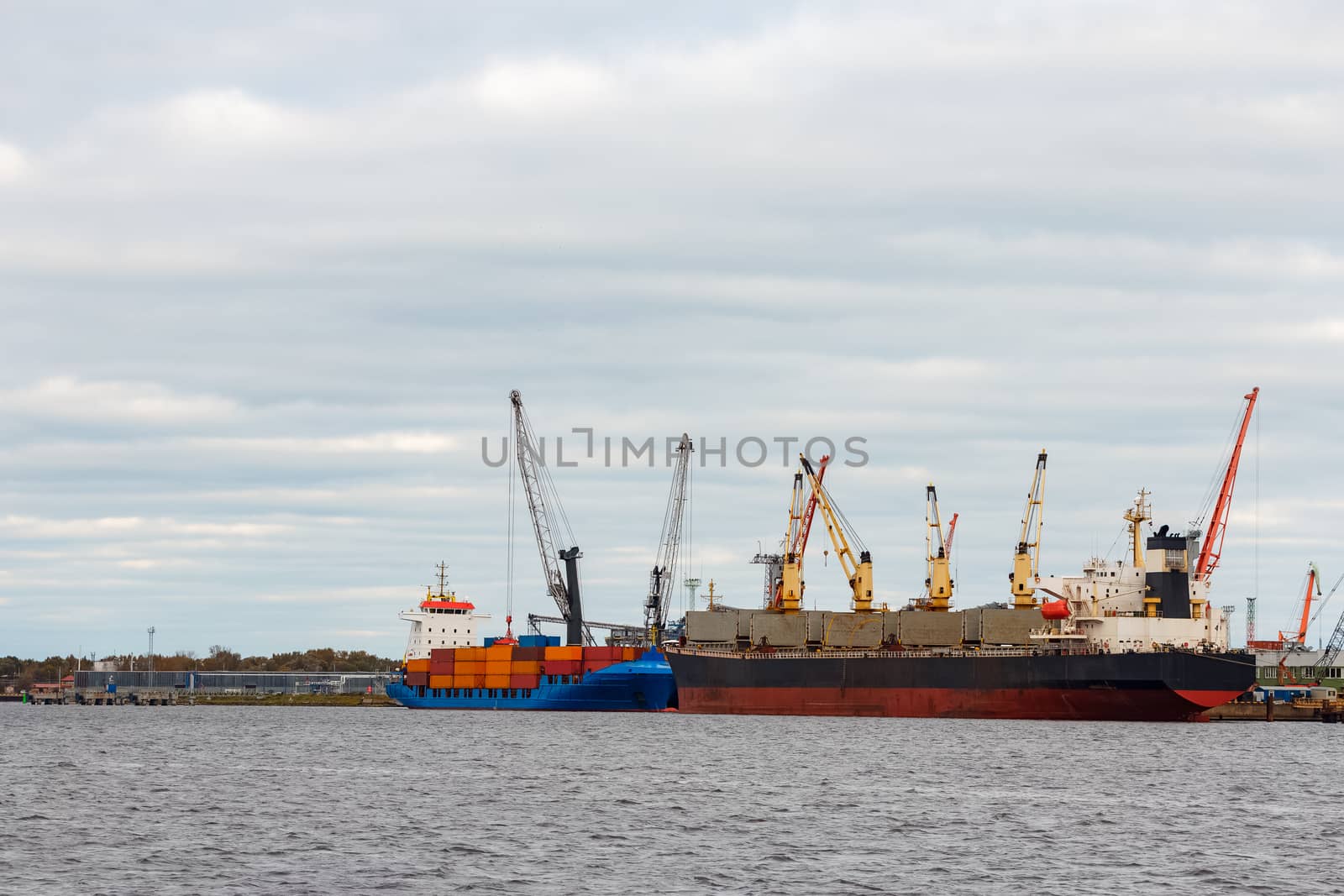 Black cargo ship loading in the port of Riga, Europe