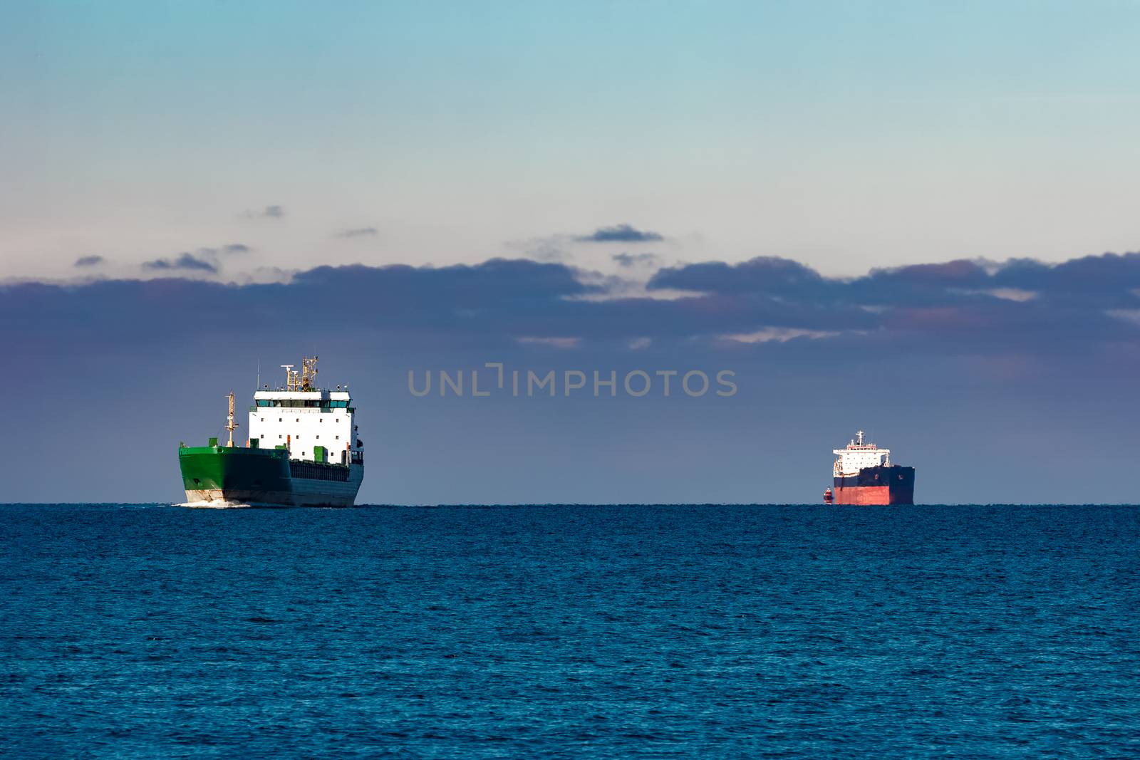 Cargo ships far in still water of Baltic sea