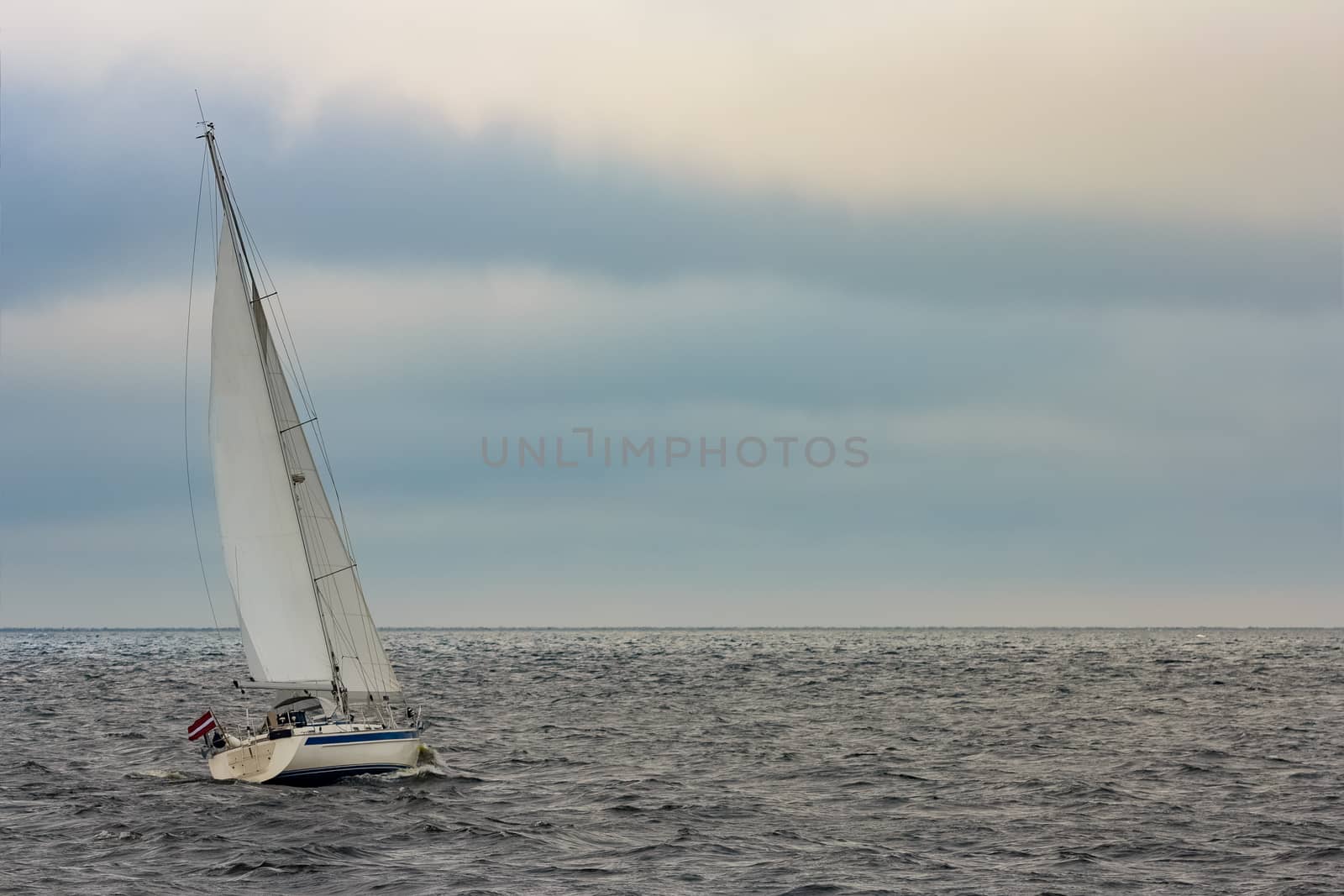 White sailboat traveling by sengnsp