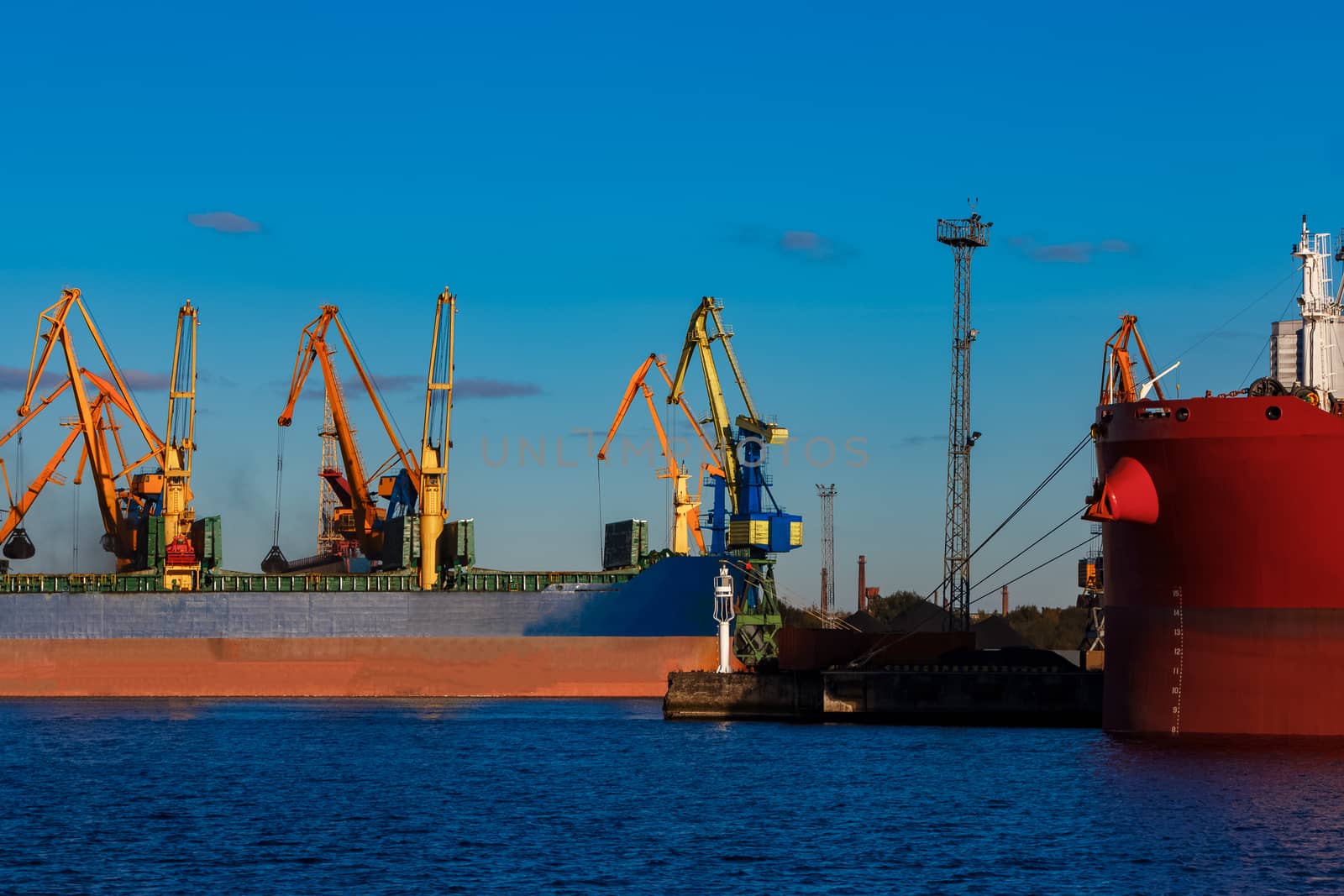 Blue cargo ship loading by sengnsp