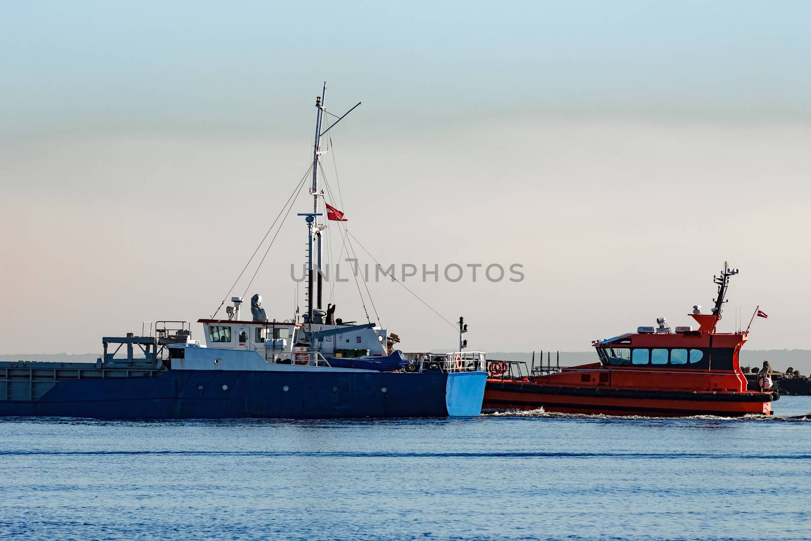 Blue cargo ship leaving Riga and entering Baltic sea