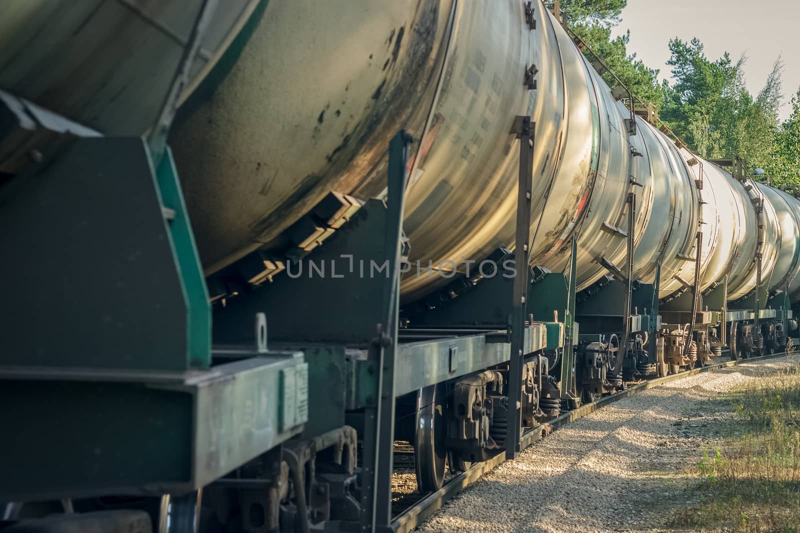 Tank wagons with oil. Freight train in forest