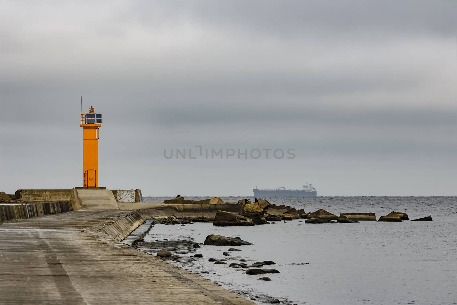 Breakwater dam with yellow lighthouse in Riga, Europe