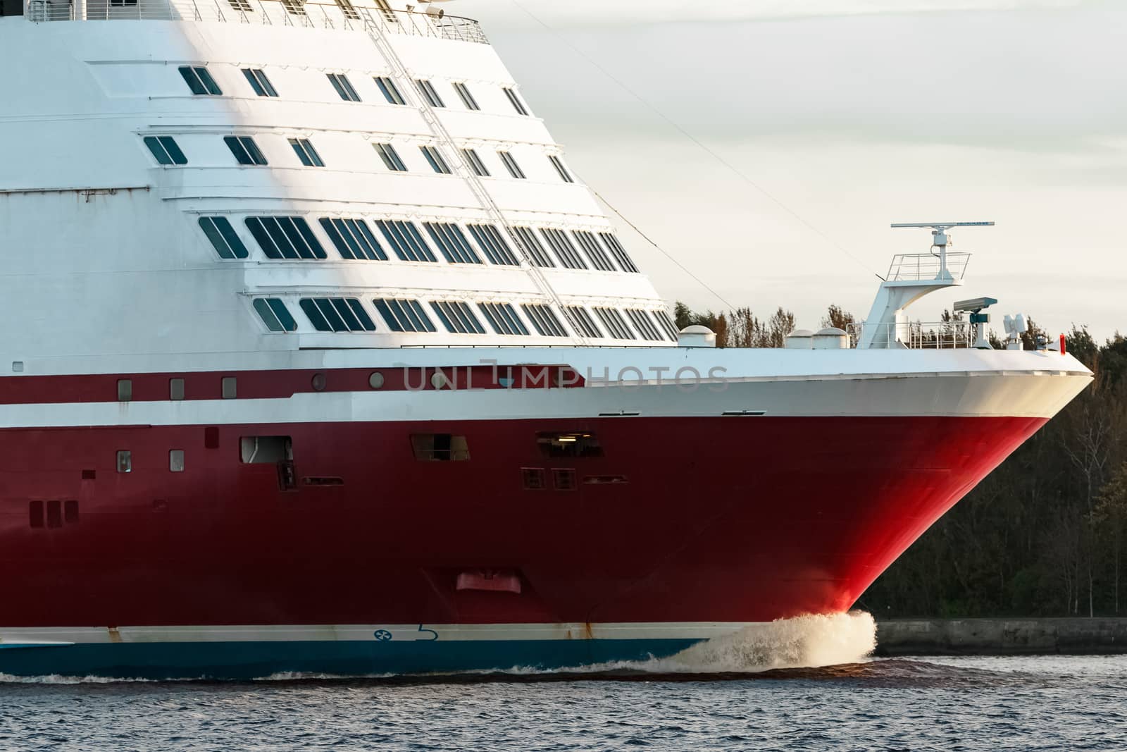 Red cruise liner's bow. Passenger ferry underway close up