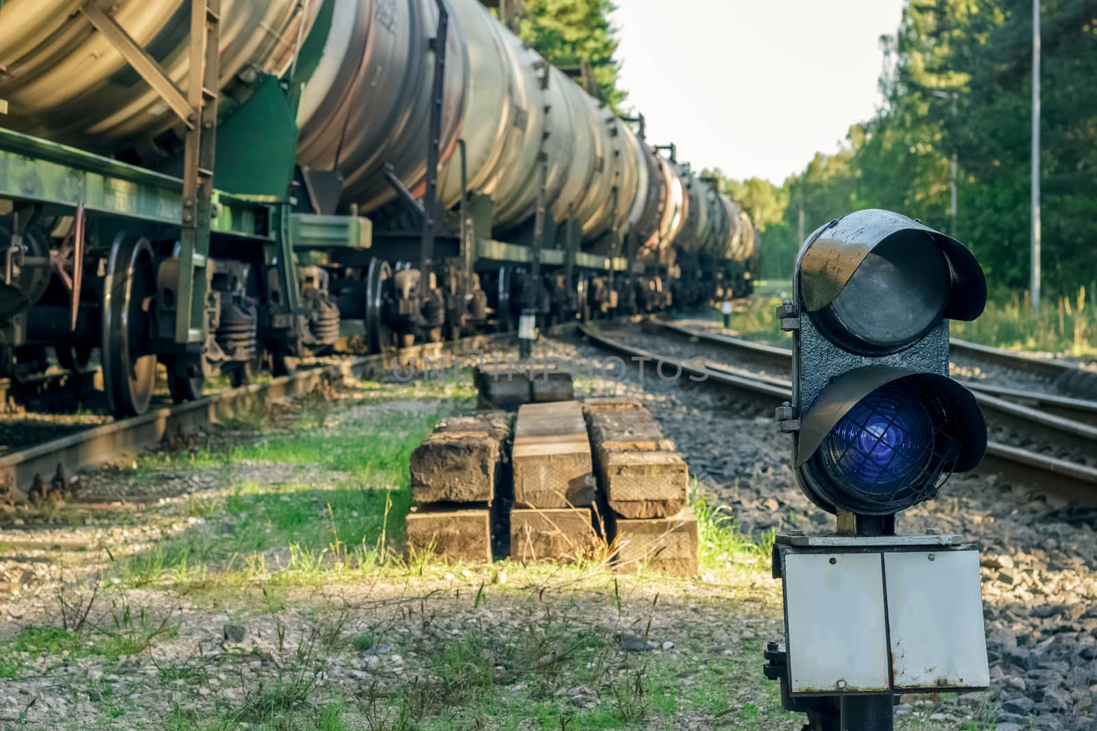 Railroad traffic light and freight train on behind