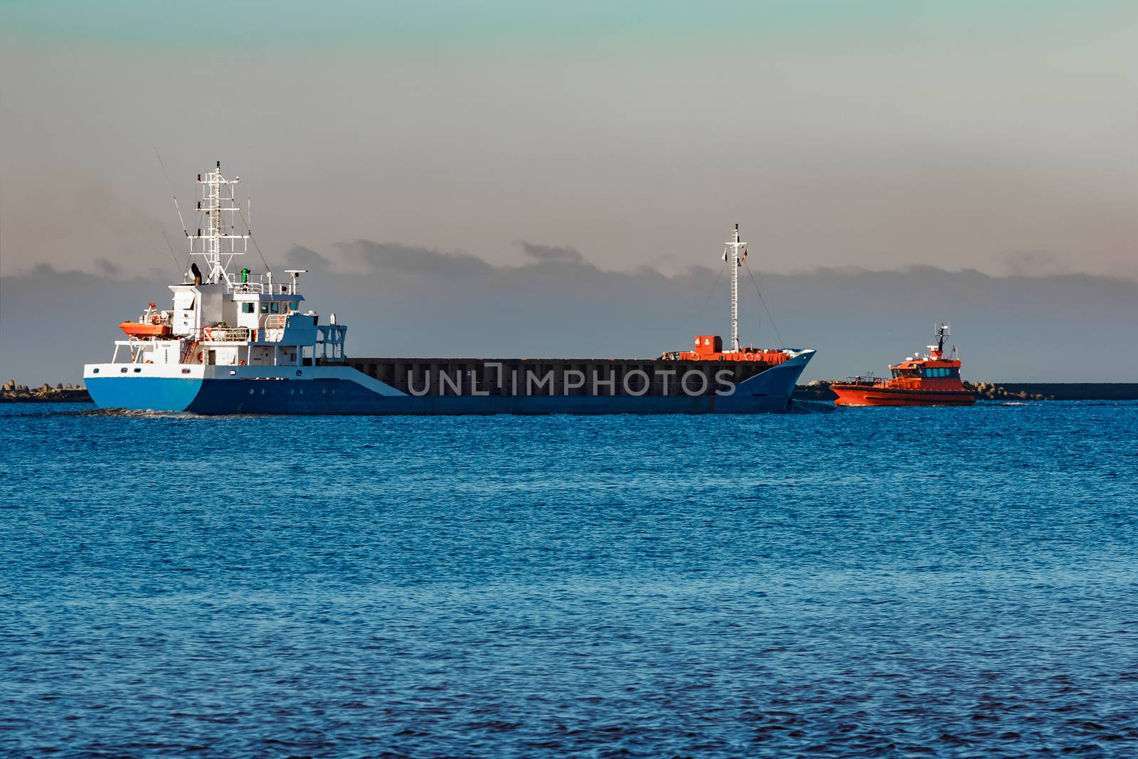 Blue cargo ship leaving Riga and entering Baltic sea