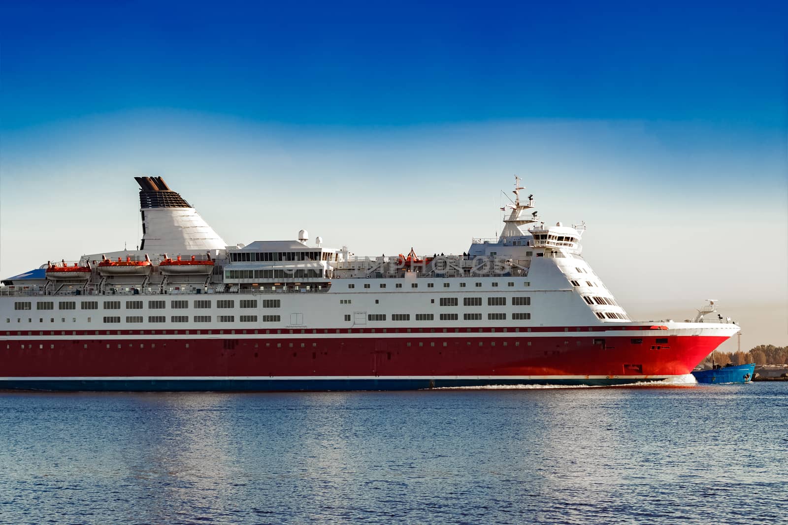 Red cruise liner. Passenger ferry ship sailing in still water