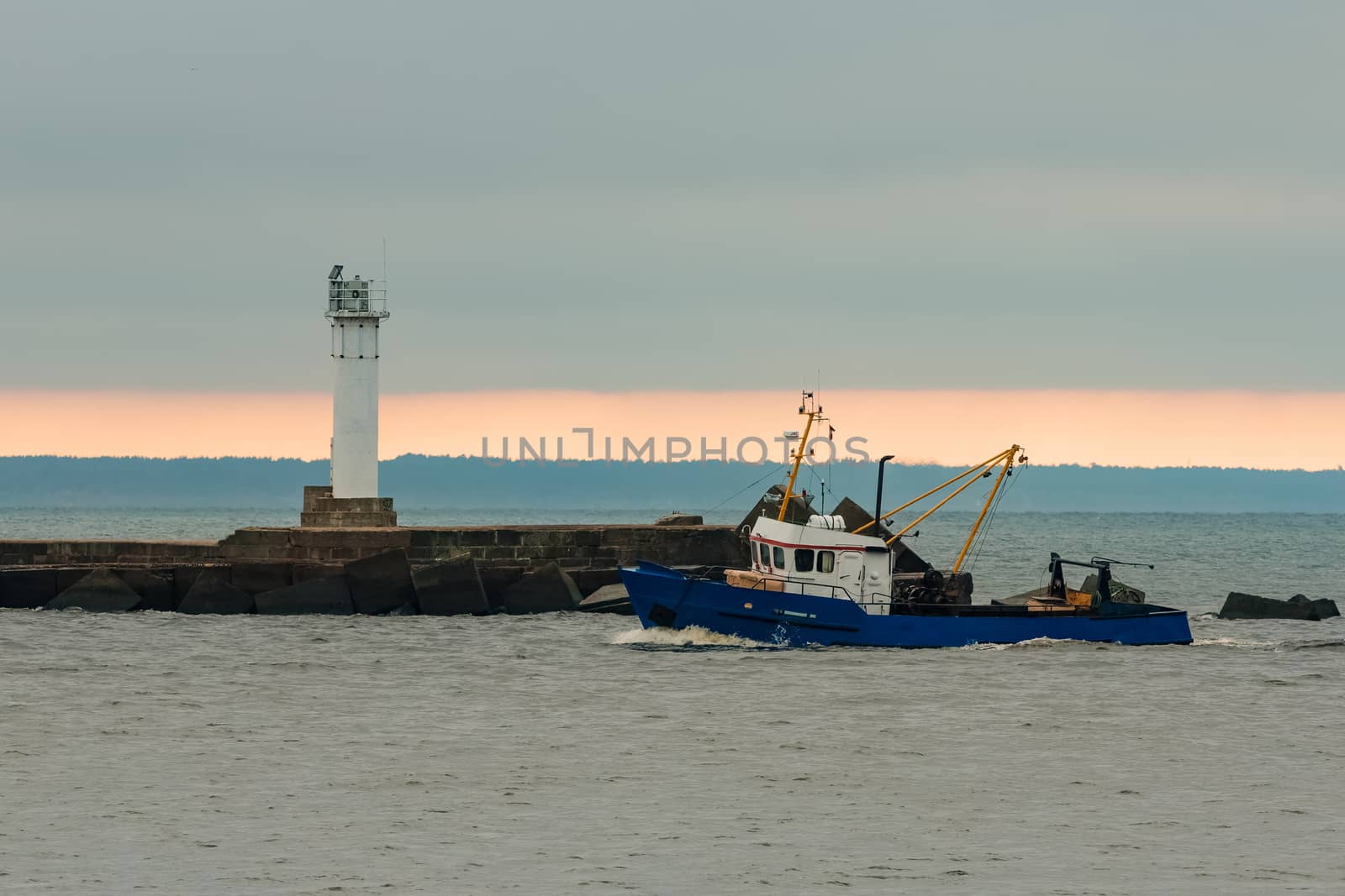 Blue fishing ship sailing in stll water