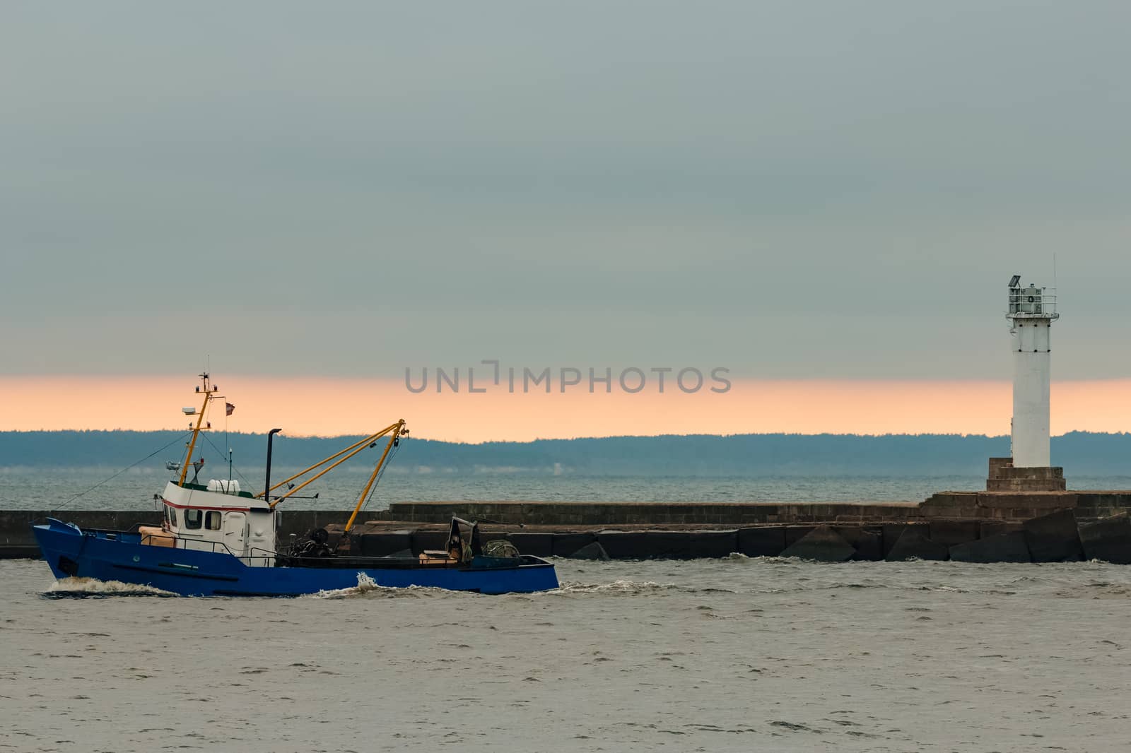 Blue fishing ship sailing in stll water