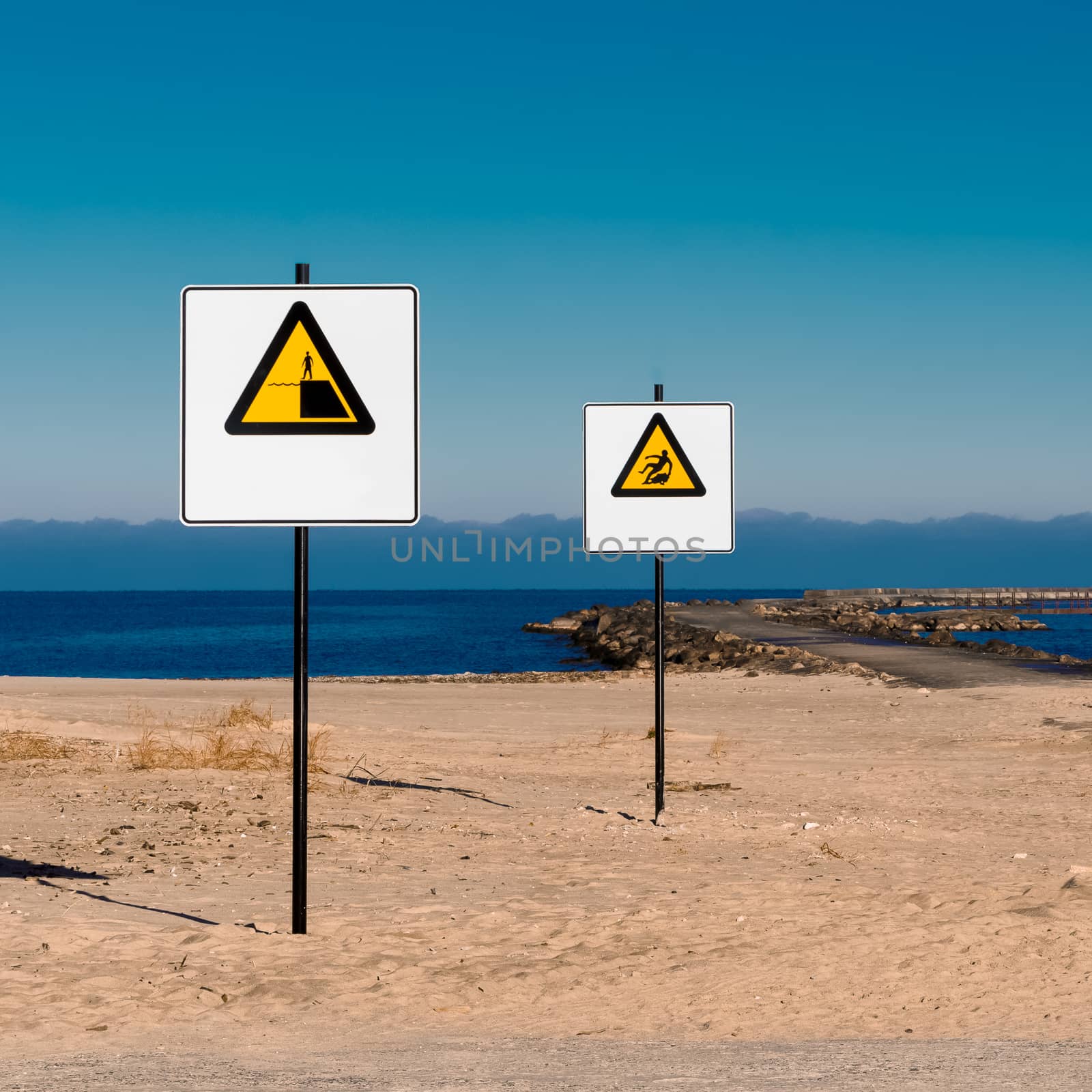 Yellow warning signs on summer beach, Riga