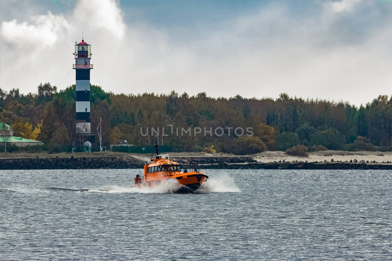 Orange pilot ship moving at speed by sengnsp