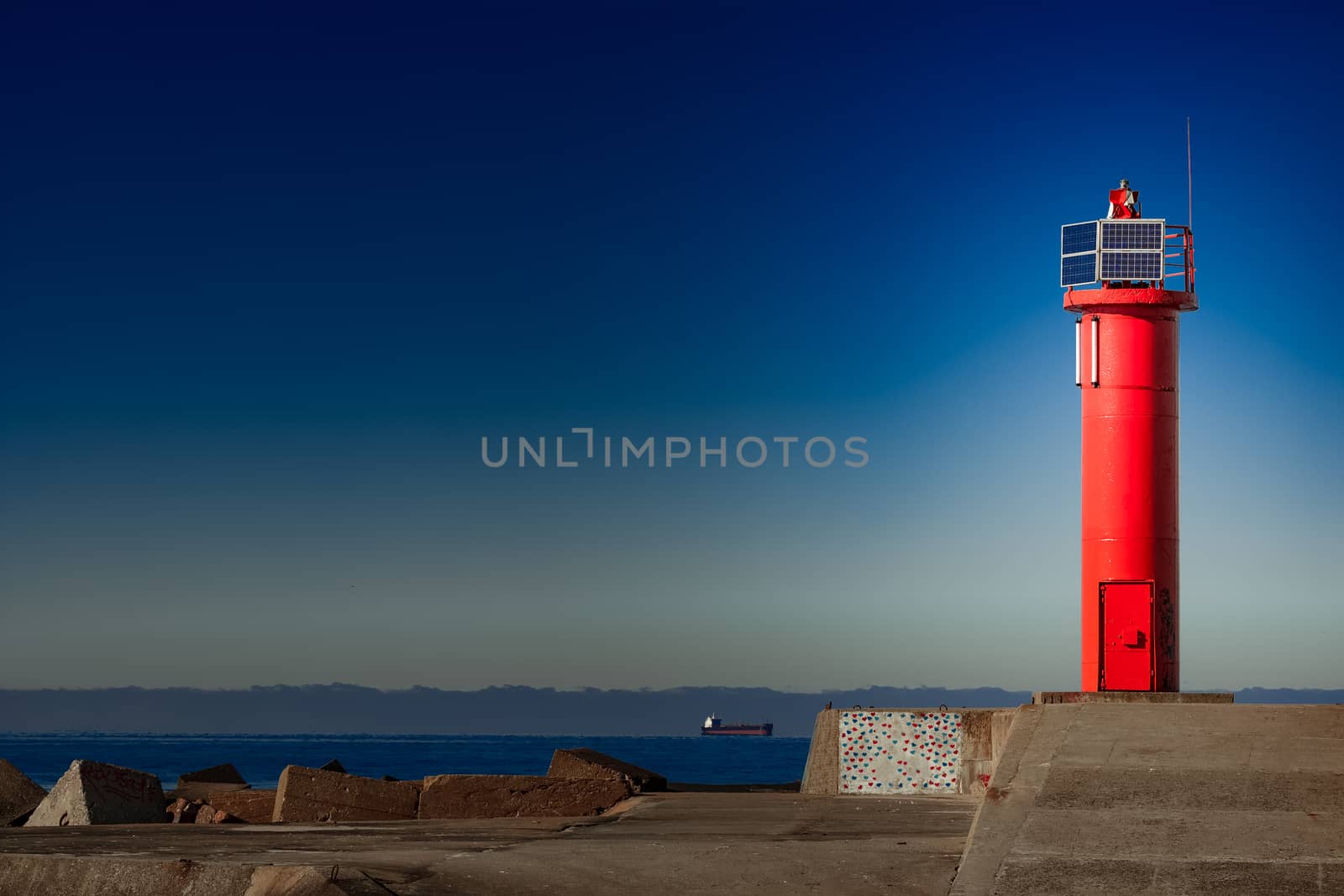 Red lighthouse on breakwater dam in Riga, Europe