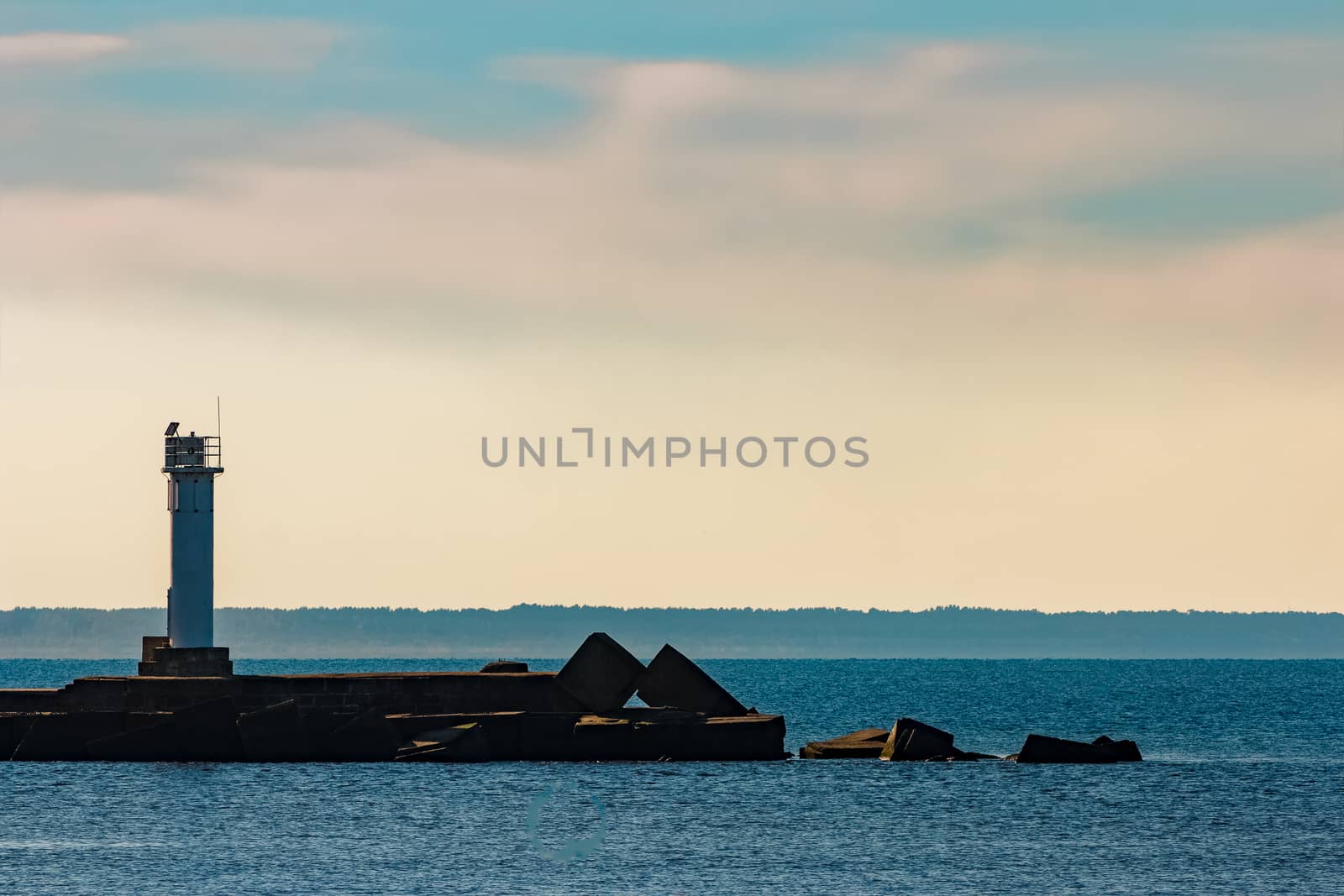 Breakwater dam with a lighthouse in the morning