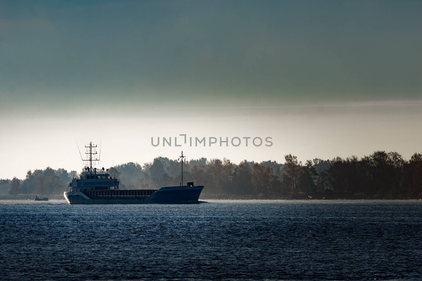 Blue cargo ship leaving Riga and entering Baltic sea