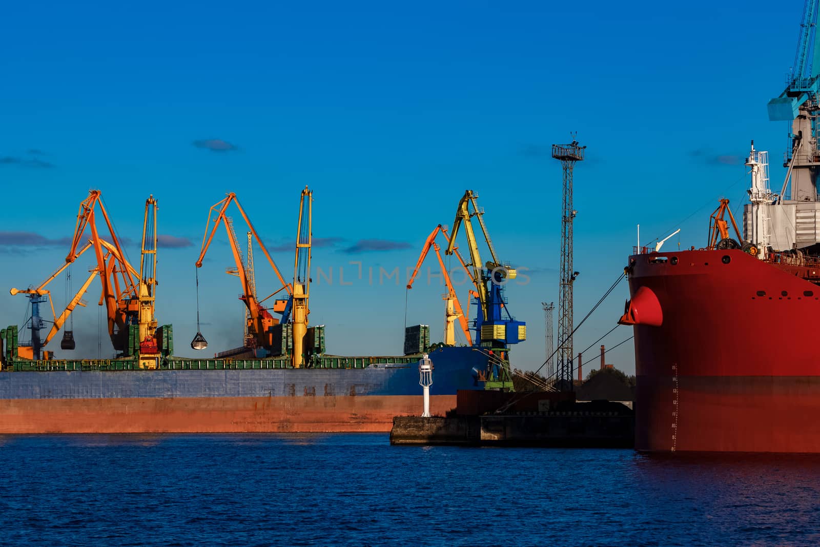 Blue cargo ship loading in the port of Riga, Europe