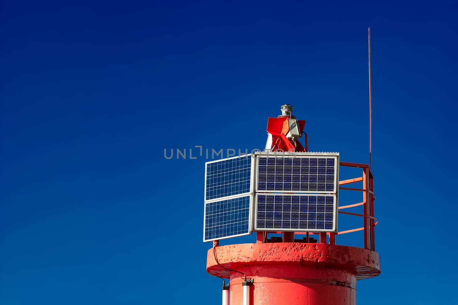 Red lighthouse against blue sky in Riga, Europe