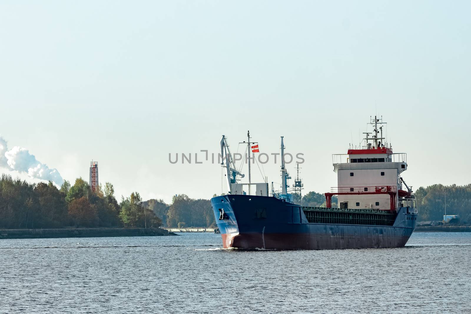 Blue cargo ship leaving the port of Riga