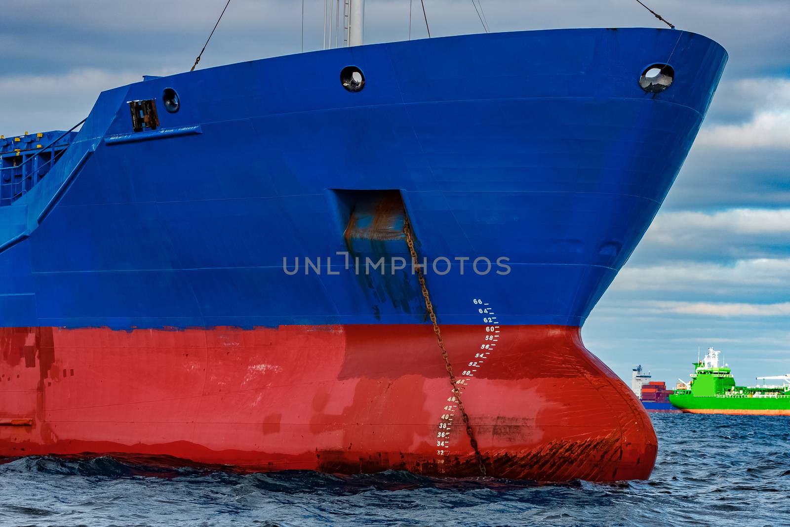 Blue cargo ship moored in still Baltic sea water