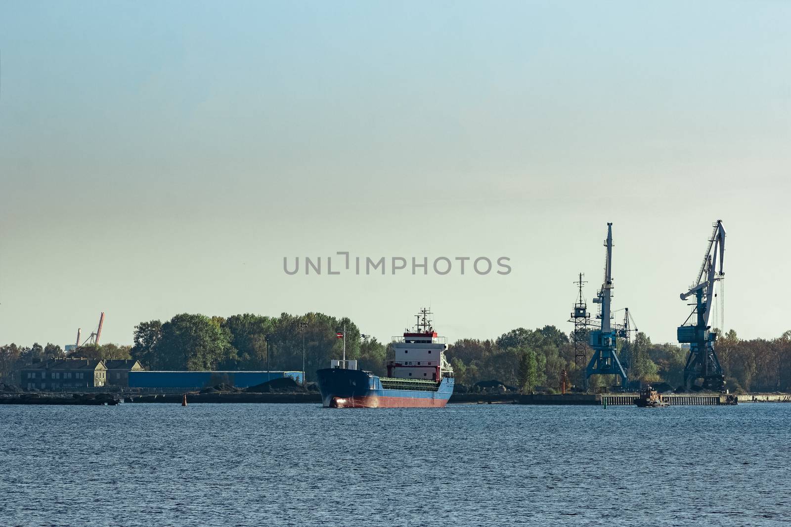 Blue cargo ship leaving the port of Riga