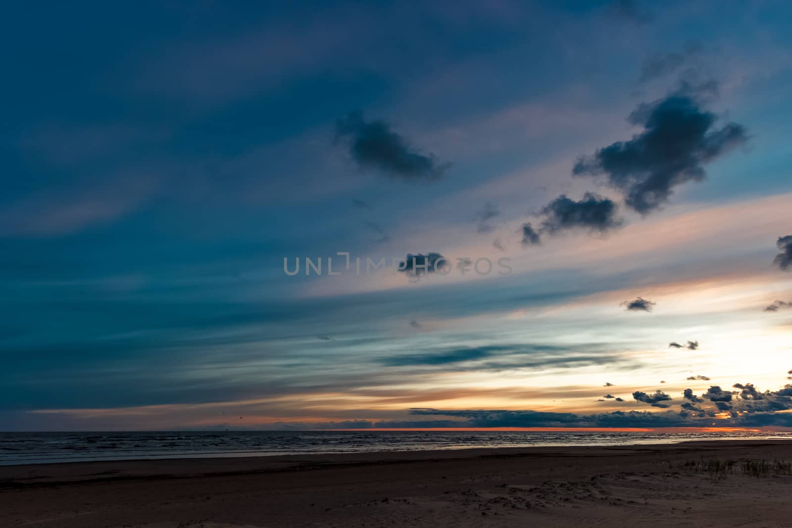 Blue cloudy sky over the Baltic sea at evening