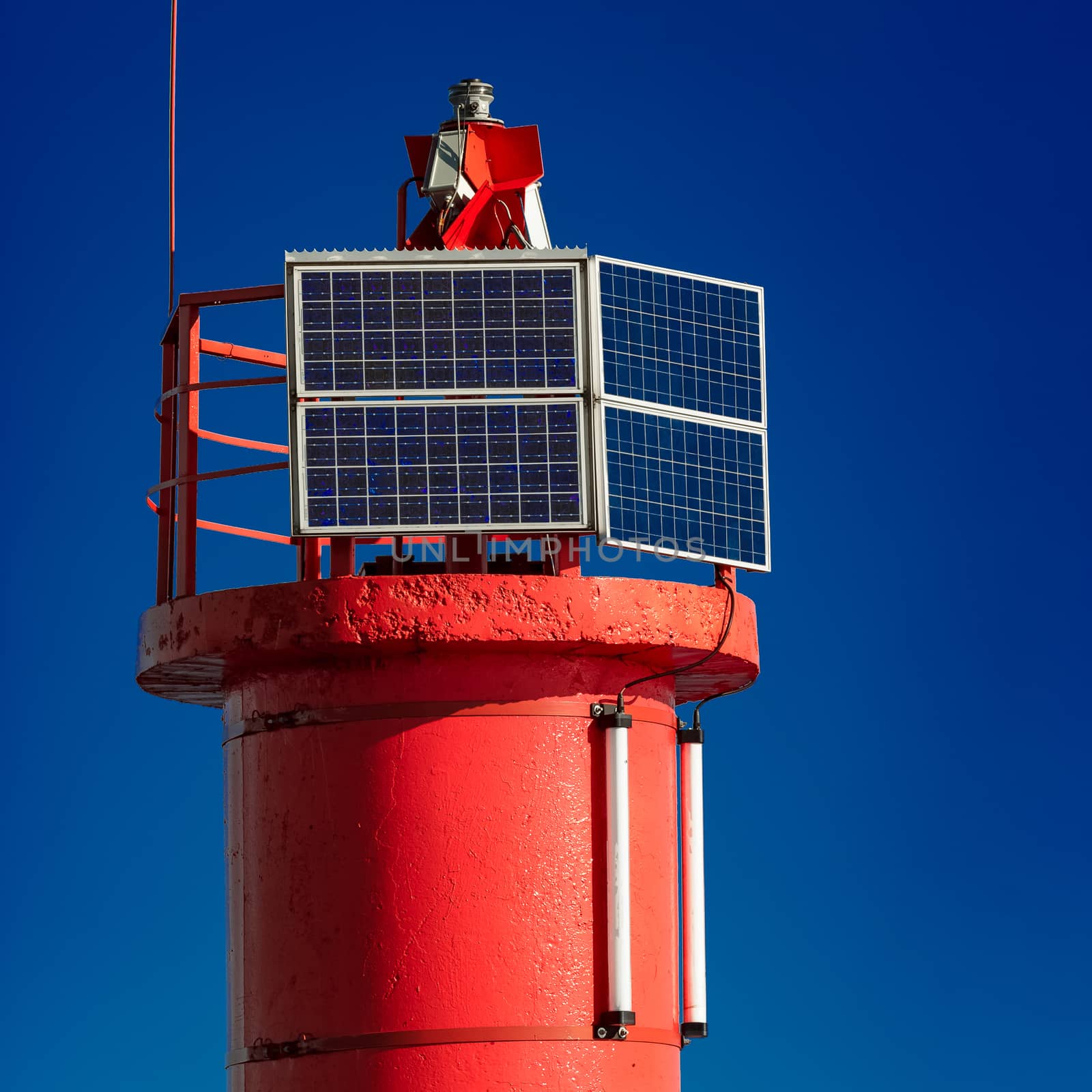 Red lighthouse against blue sky in Riga, Europe