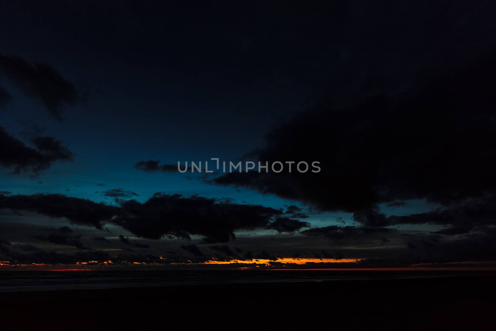 Dark blue cloudy sky over the Baltic sea at night