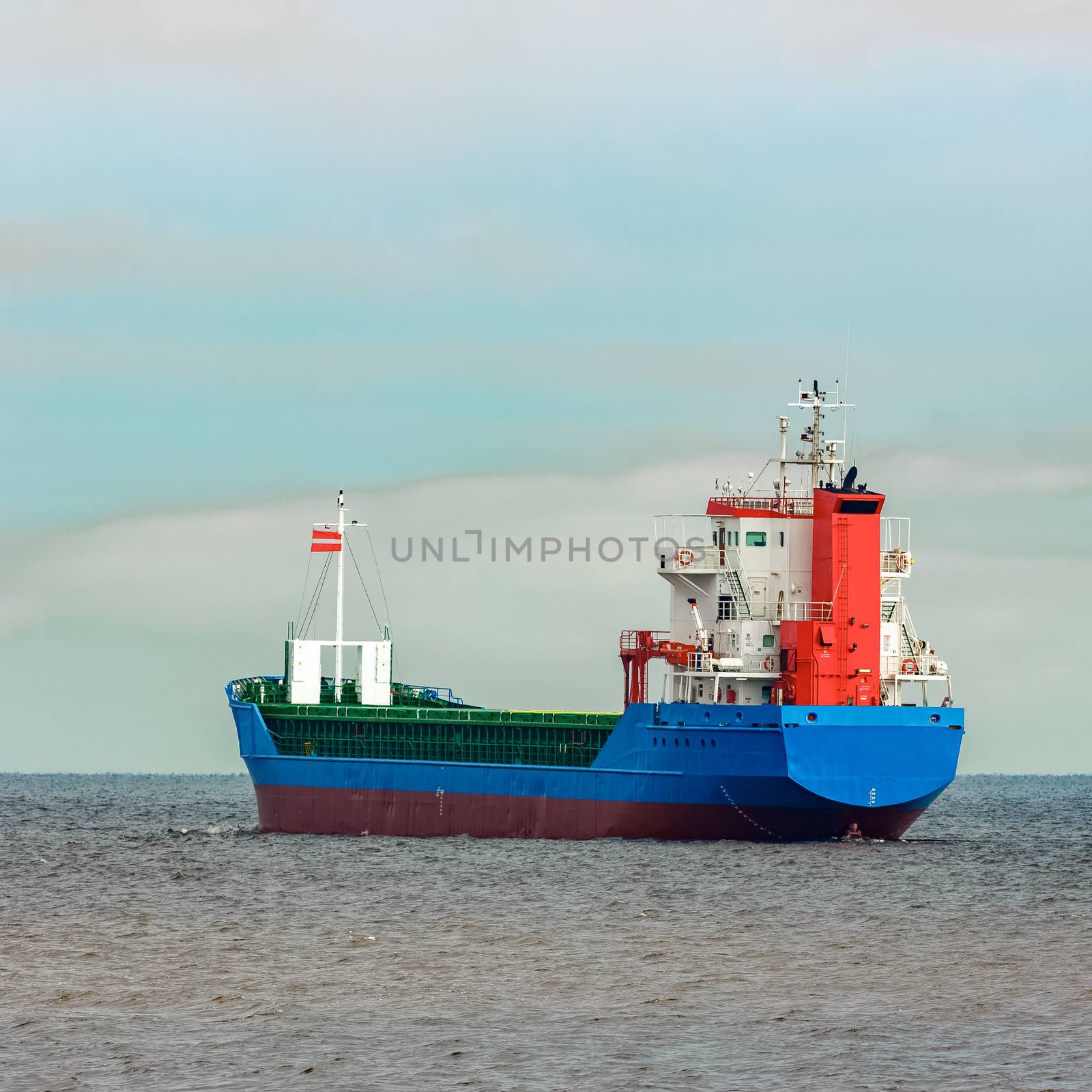 Blue cargo ship entering the Baltic sea. Riga, Europe