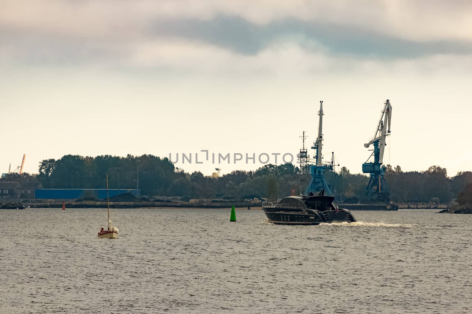 Black elite speed motor boat entering Riga