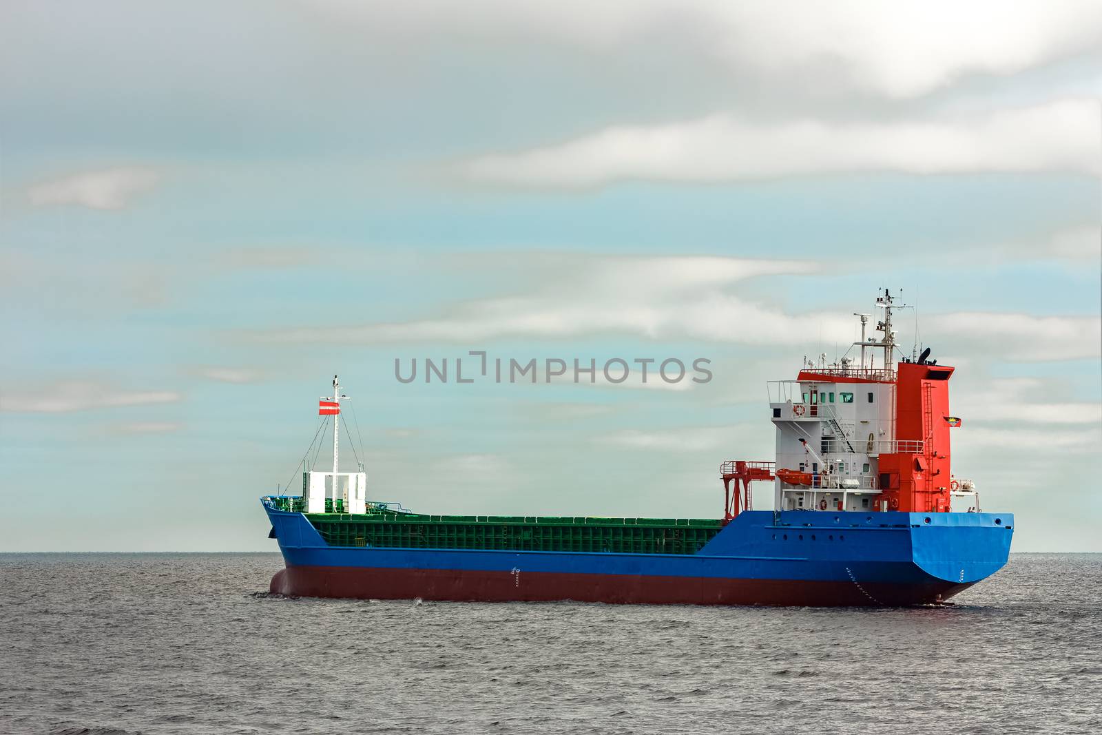 Blue cargo ship entering the Baltic sea. Riga, Europe