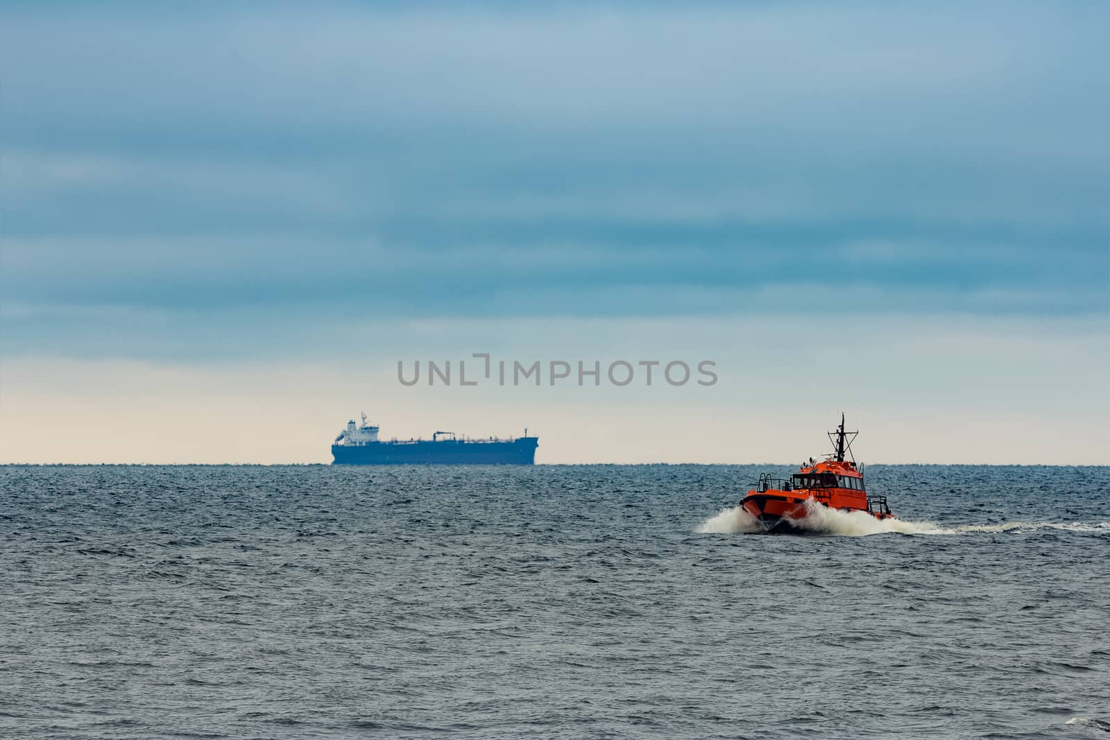 Red pilot ship moving at speed in Baltic sea