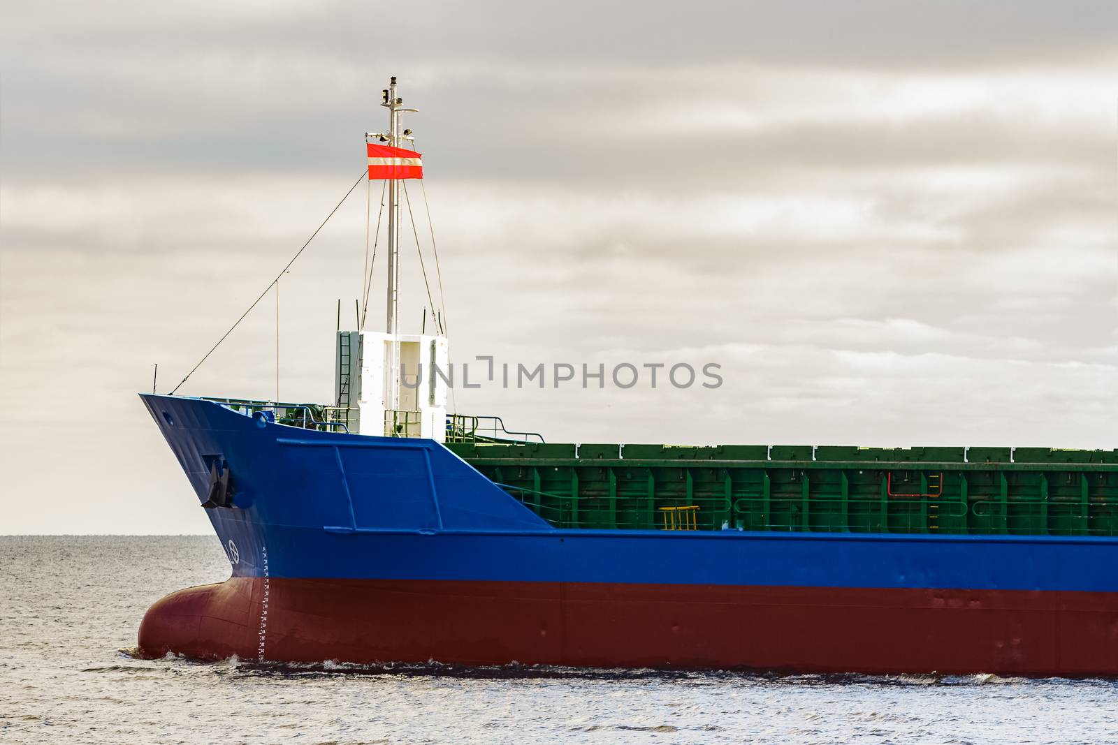 Blue cargo ship's bow leaving the port of Riga