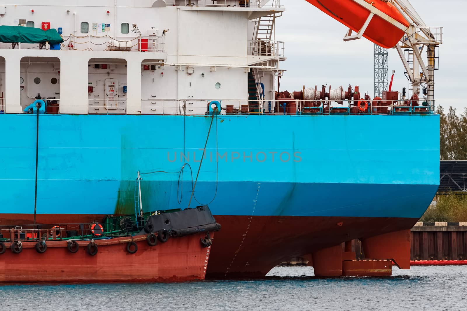 Blue cargo ship loading in the port of Riga, Europe