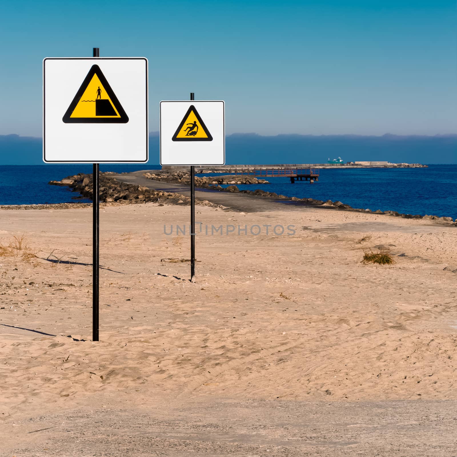 Yellow warning signs on summer beach, Riga