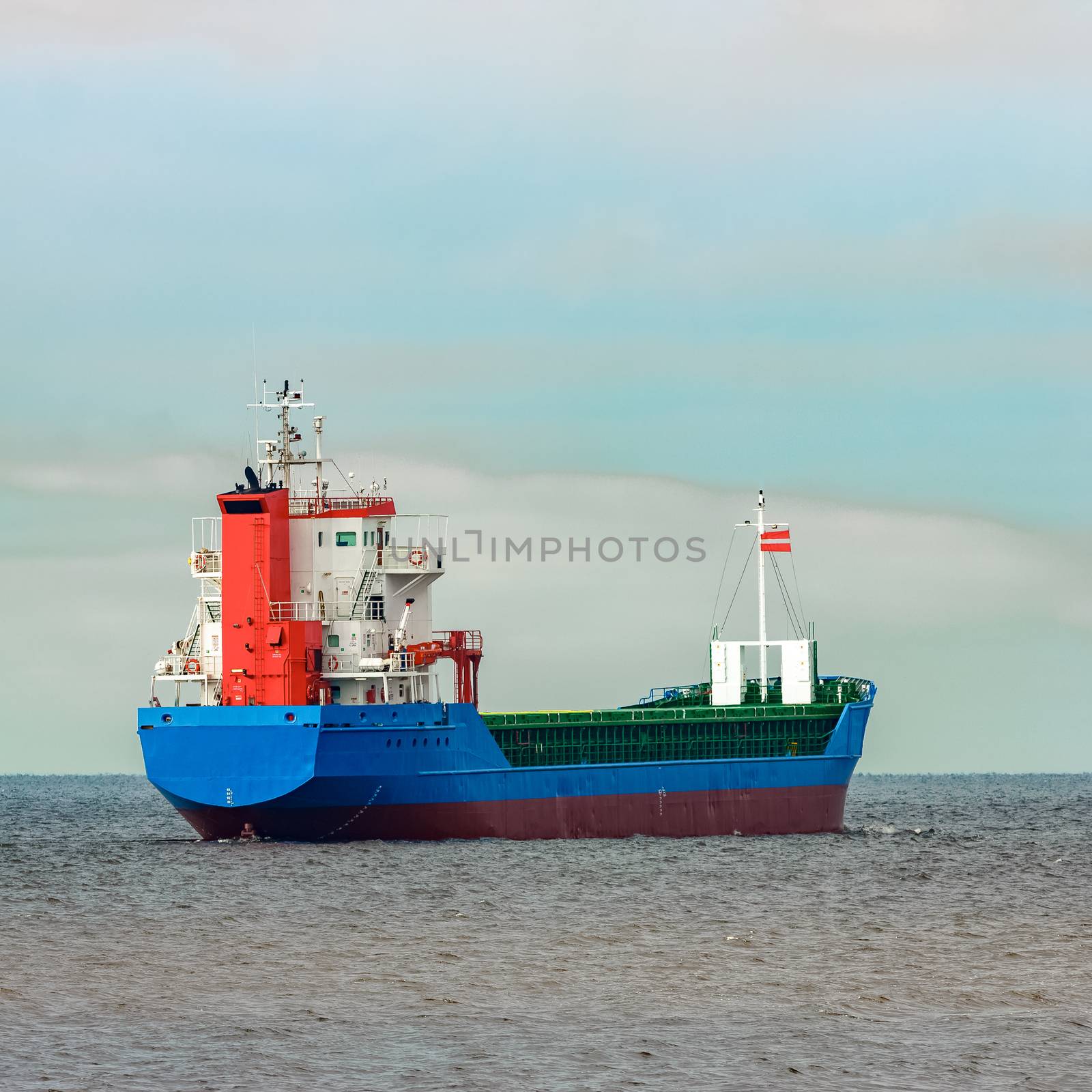 Blue cargo ship entering the Baltic sea. Riga, Europe