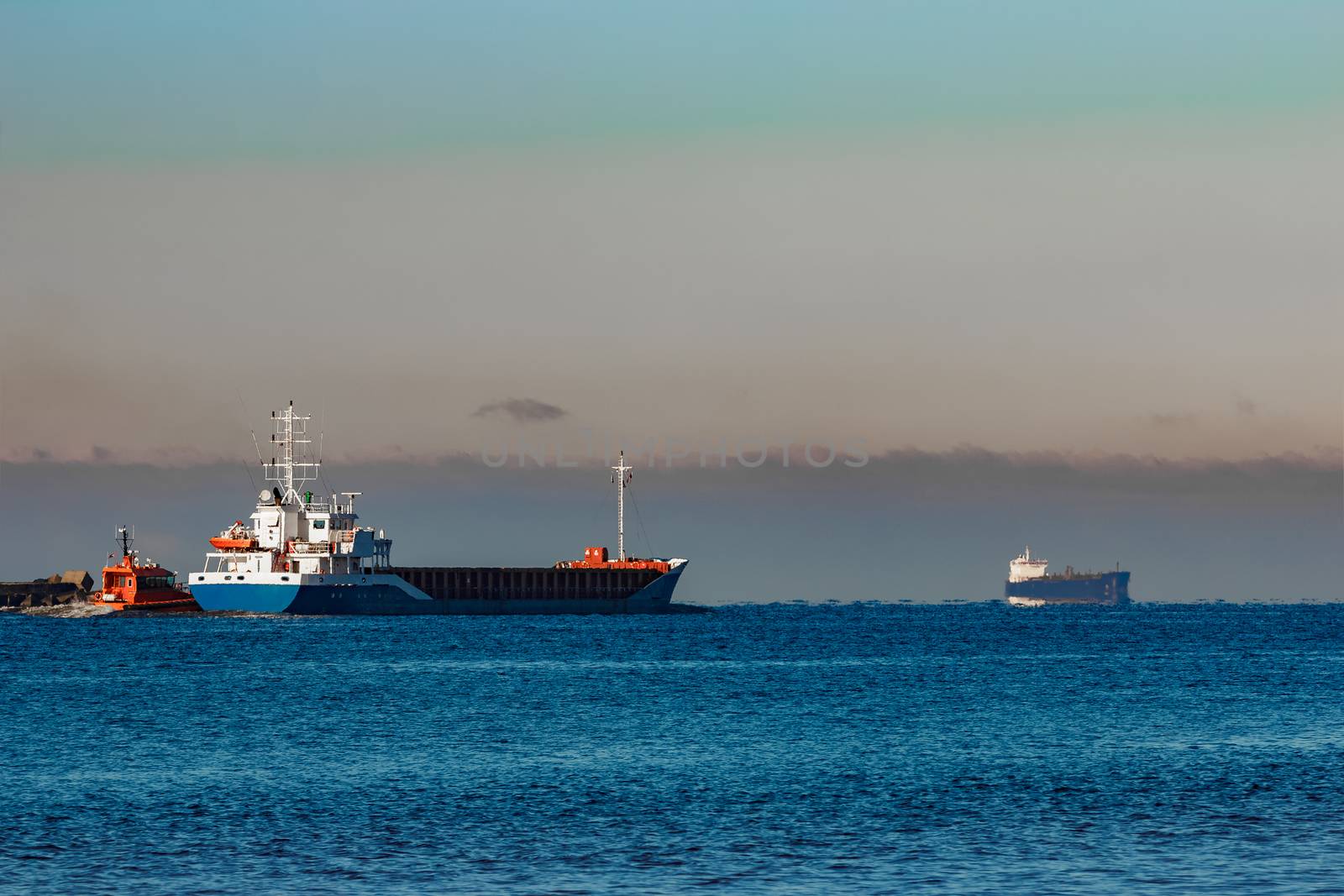 Blue cargo ship leaving Riga and entering Baltic sea