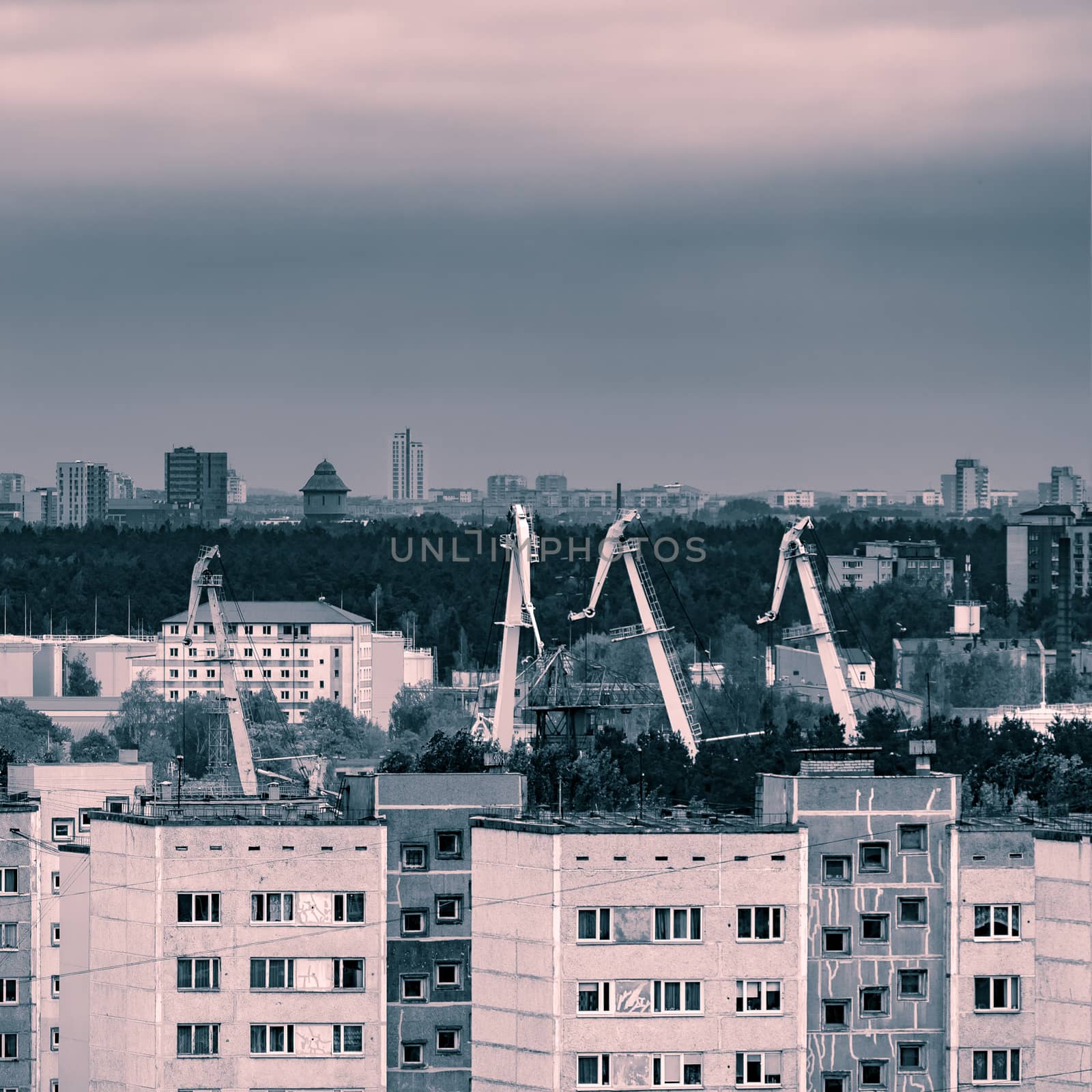 Residential area in Riga with soviet houses and cargo cranes